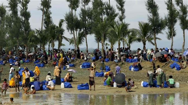 In this photo taken on September 04, 2017, displaced Rohingya refugees from Rakhine state in Myanmar rest near Ukhia, at the border between Bangladesh and Myanmar, as they flee violence. (Photo by AFP)
