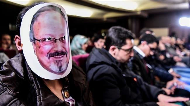 A man wears a mask of killed journalist Jamal Khashoggi during a commemoration event of Khashoggi