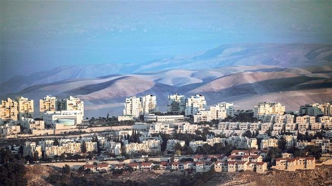 This picture, taken on November 17, 2018, from East Jerusalem al-Quds shows a view of the illegal Israeli settlement of Maale Adumim (C) with the Judaean desert seen in the background. (By AFP)
