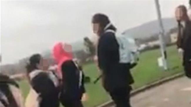 This blurred image taken from a video posted on the social media on November 27, 2018 purportedly shows a Syrian refugee girl being attacked in a school in Huddersfield, in northern England over wearing hijab.
