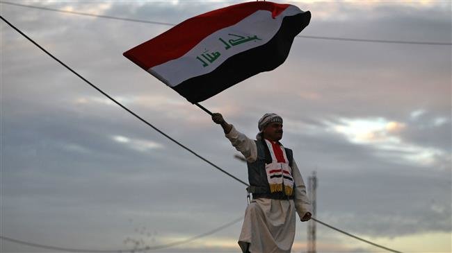 In this file photo, taken on December 10, 2017, an Iraqi man is seen waving a national flag in Baghdad