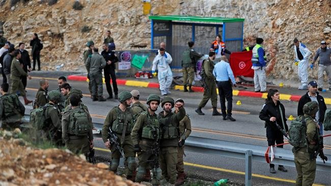 Israeli forces and forensic inspect the site of a drive-by shooting attack in the West Bank settlement of Givat Asaf, northeast of Ramallah, on December 13, 2018. (By AFP)
