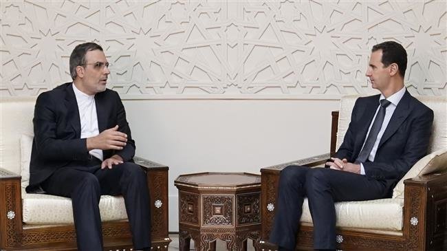 A handout picture released by the official Syrian Arab News Agency (SANA) on November 12, 2018 shows Syrian President Bashar al-Assad (R) meeting with assistant Iranian foreign minister, Hossein Jaberi Ansari, in Damascus.
