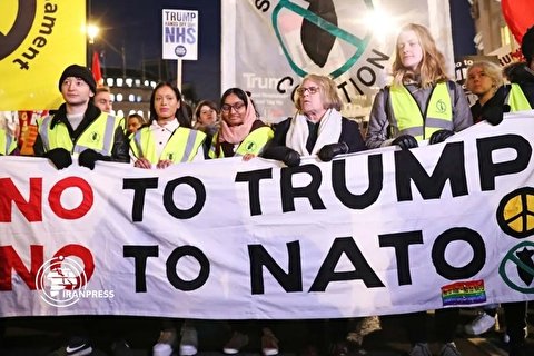 Protesters march to Buckingham Palace as NATO leaders attend reception
